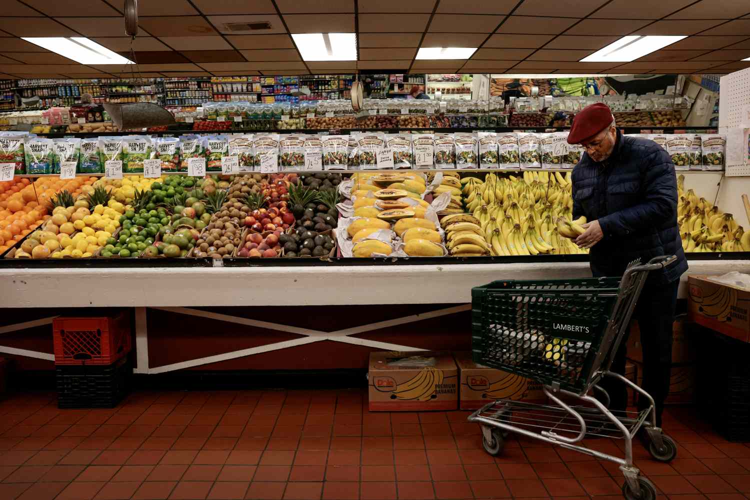 A customer shops in the produce department at Lambert's Rainbow Market.