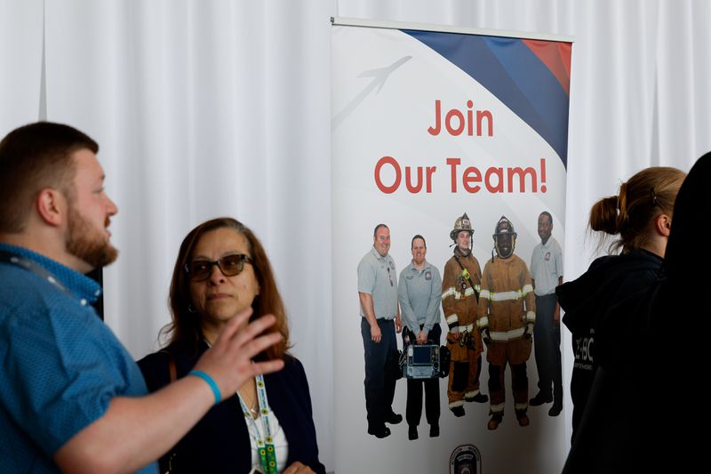 "Join Our Team" signage during a job fair hosted by the Metropolitan Washington Airports Authority to support federal workers looking for new career opportunities