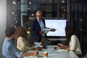 Businessman giving a presentation to his colleagues in the boardroom.