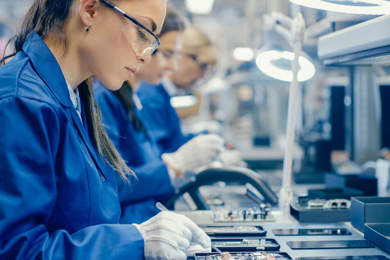 Workers in a factory assembling smartphones