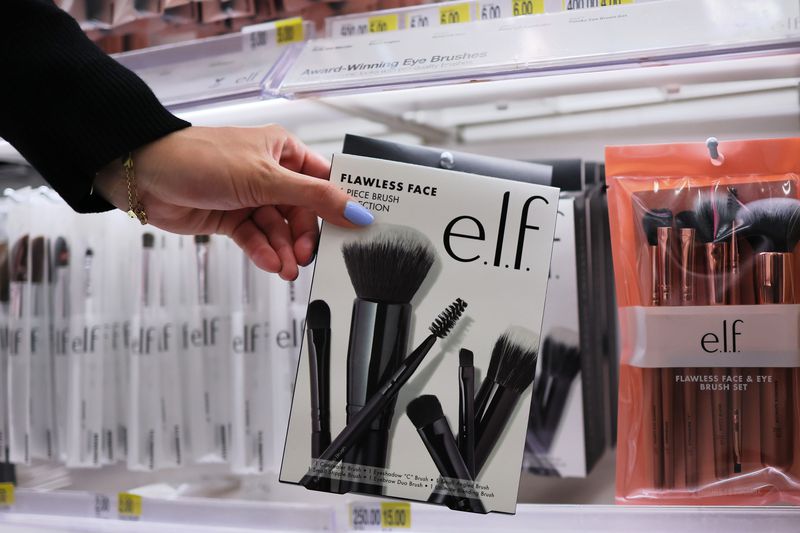 A customer reaches for an E.l.f. product. 