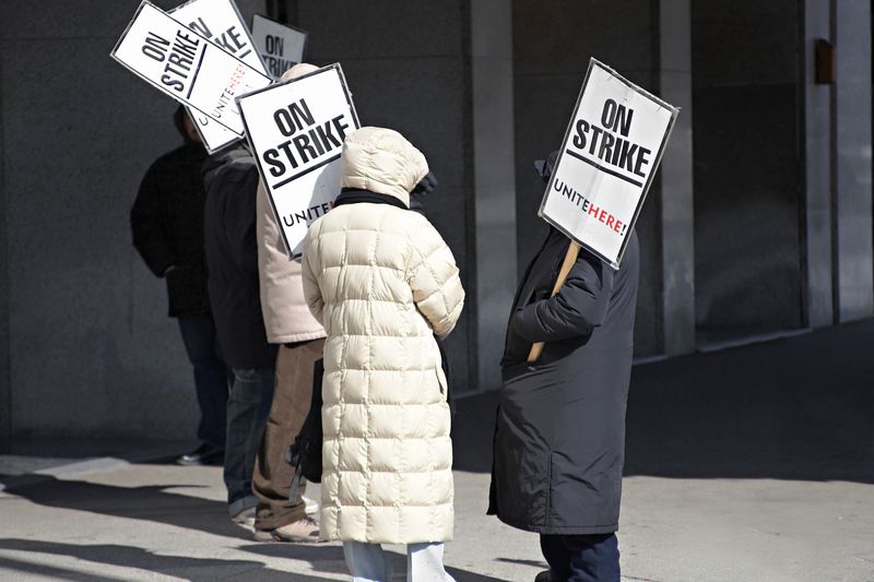 A group of union workers on strike is an indication of organized labor practices.