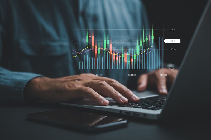 An investor trading stocks on their computer at home 