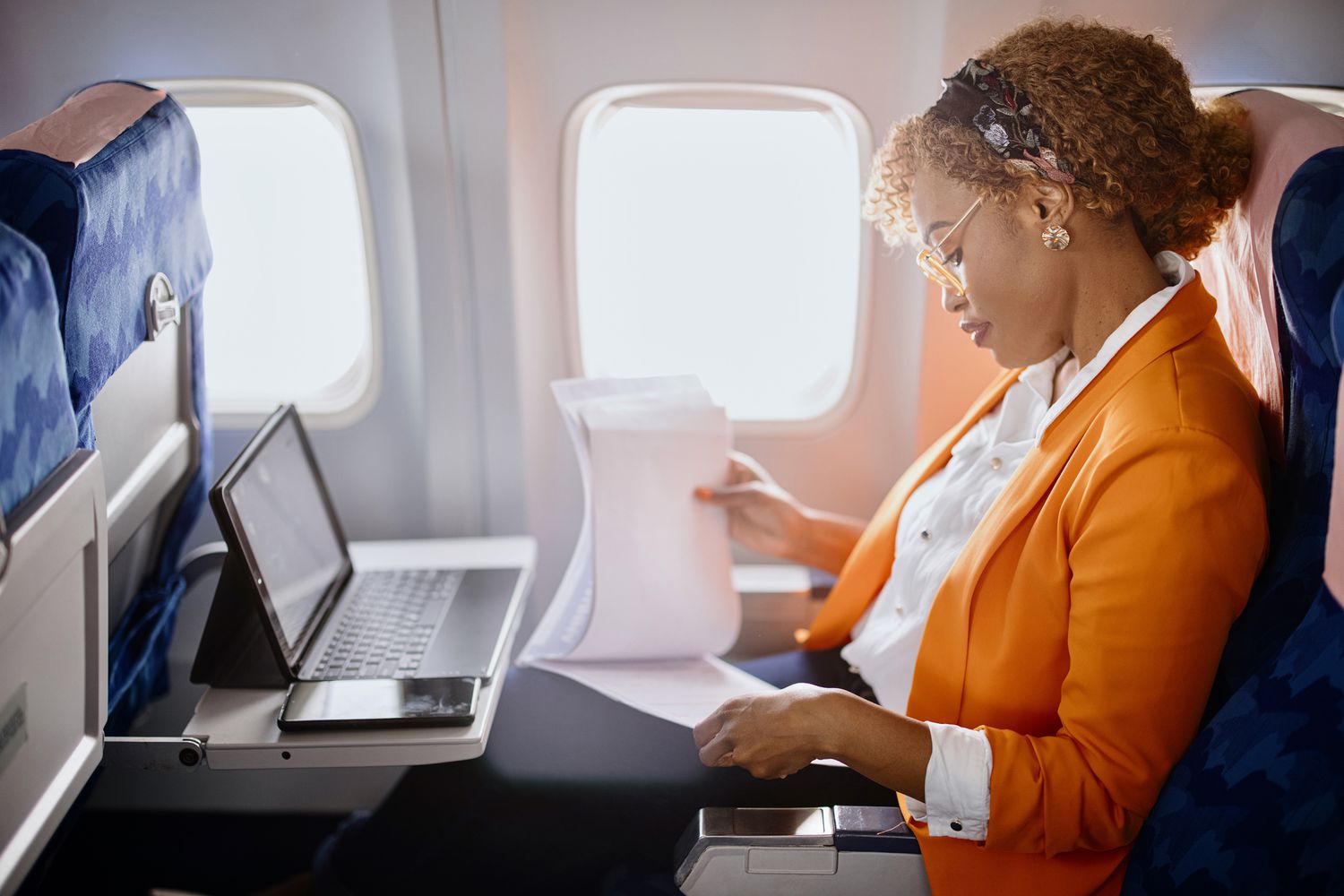A woman works on a plane. 