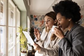 Two women looking at a mobile device