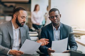 Colleagues working together, looking at papers
