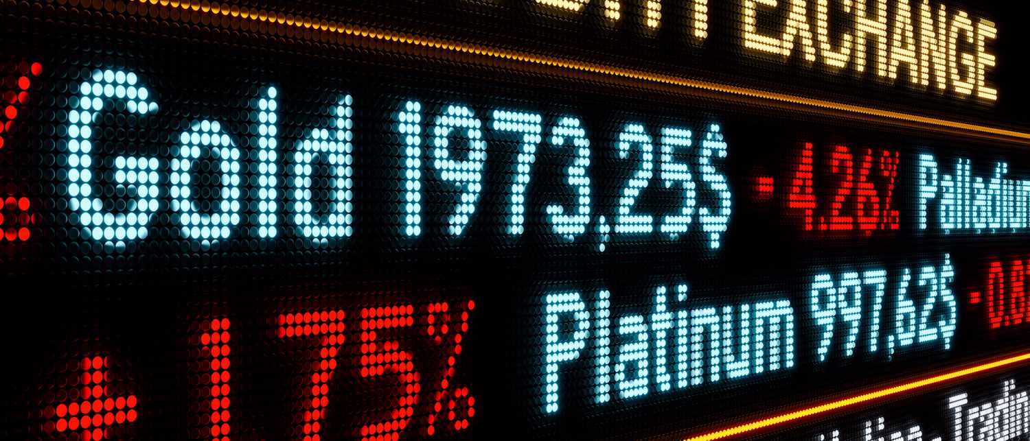 A close up view of an LED stock ticker showing the current price for gold, palladium, and platinum. 