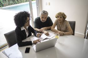 Financial advisor helping a senior couple at home