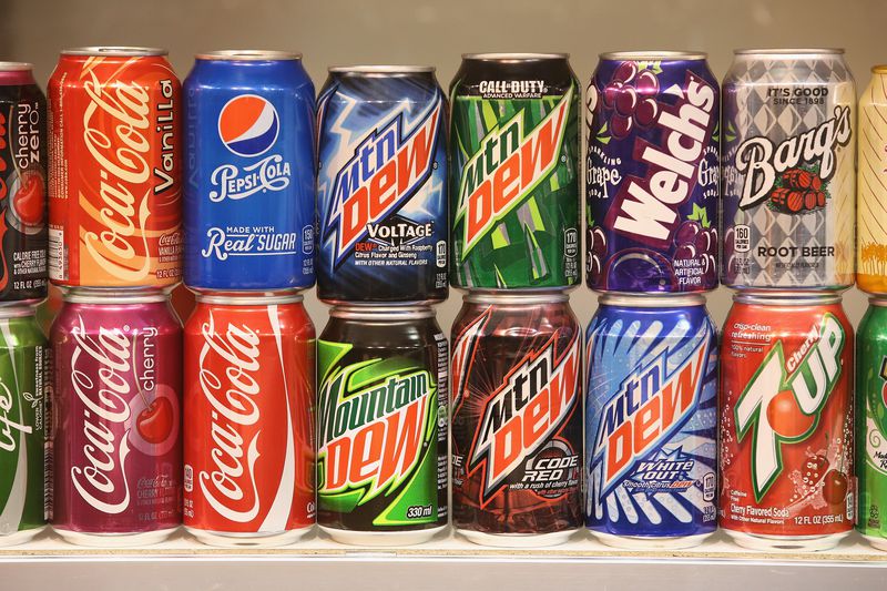lines of cans from pepsi and coca cola
