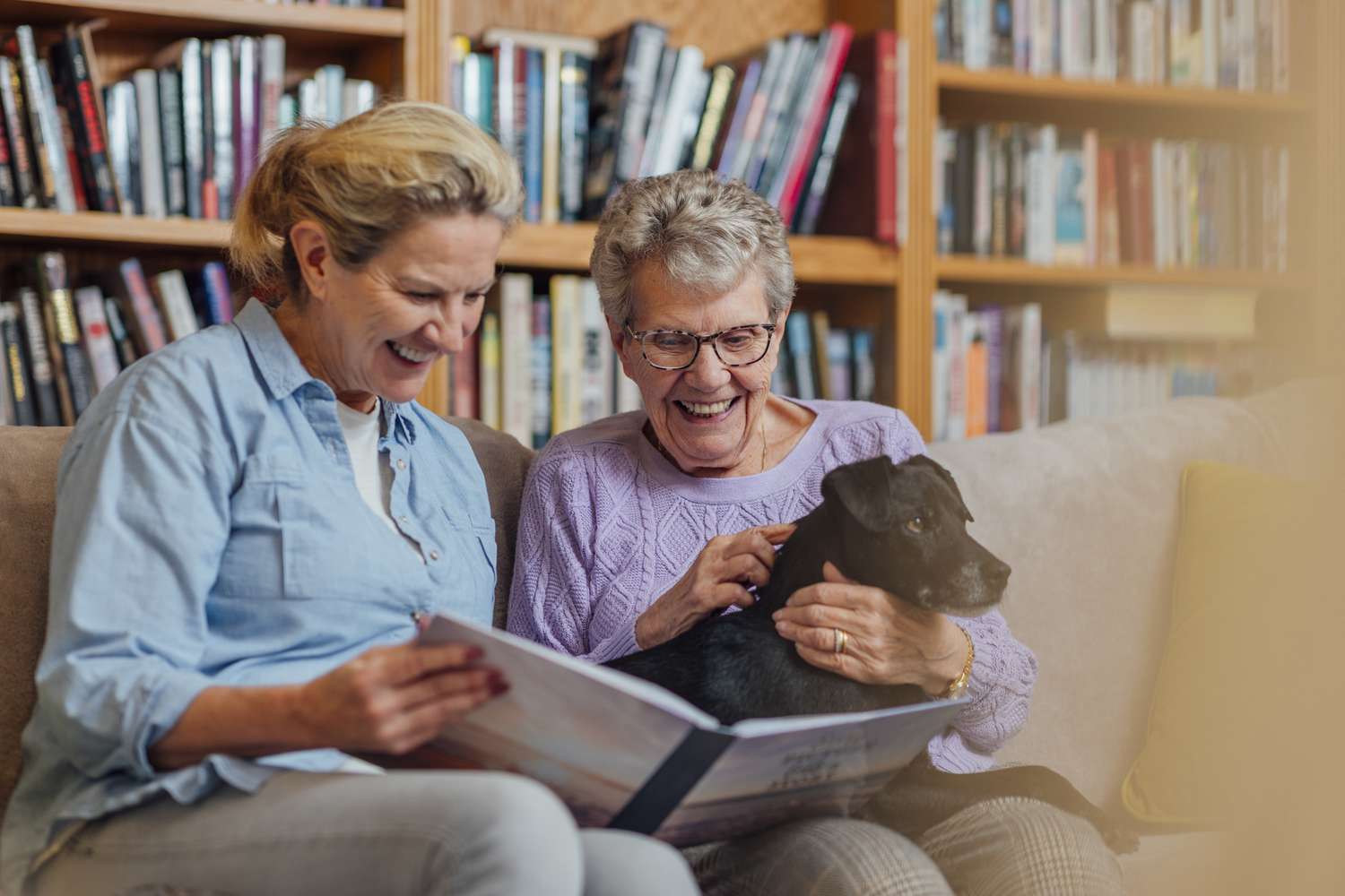 Two women look at a photo album