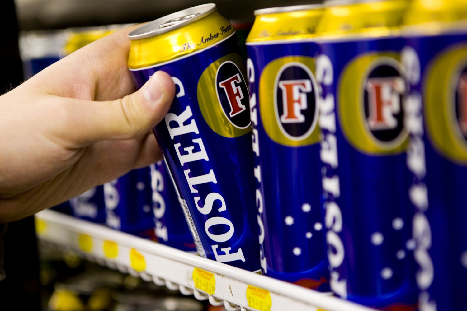 Fosters lager being pulled off of a shelf.