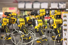 Yellow and black DeWalt power tools are seen as part of a display at Home Depot
