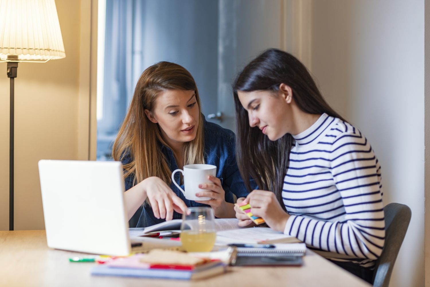 Mother and daughter researching how much free college aid students are missing out on