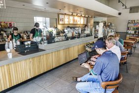 Guests use computers at a Starbucks.