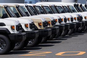 Toyota trucks awaiting shipment are parked at a port on March 27, 2025 in Yokohama, Japan
