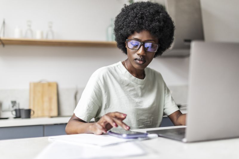 A worker with a computer and a phone