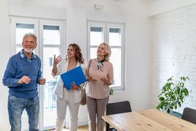 A couple looks at a home with a real estate agent
