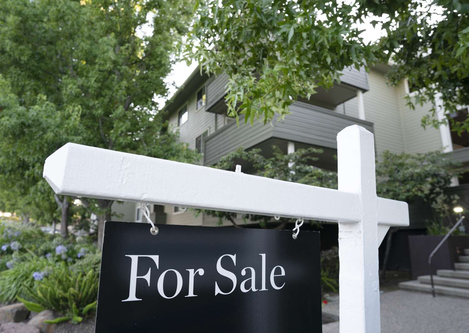 A for sale sign hangs in front of a home on August 22, 2023 in San Mateo County, California. 
