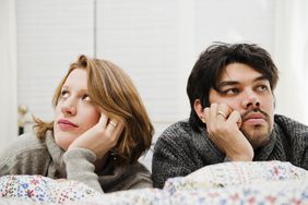 Married couple looking off in different directions