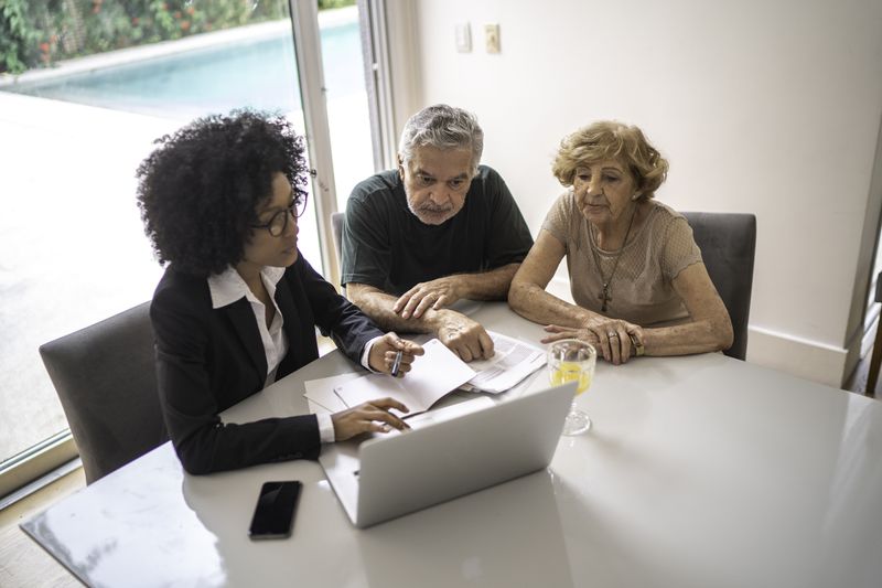 Financial advisor helping a senior couple at home