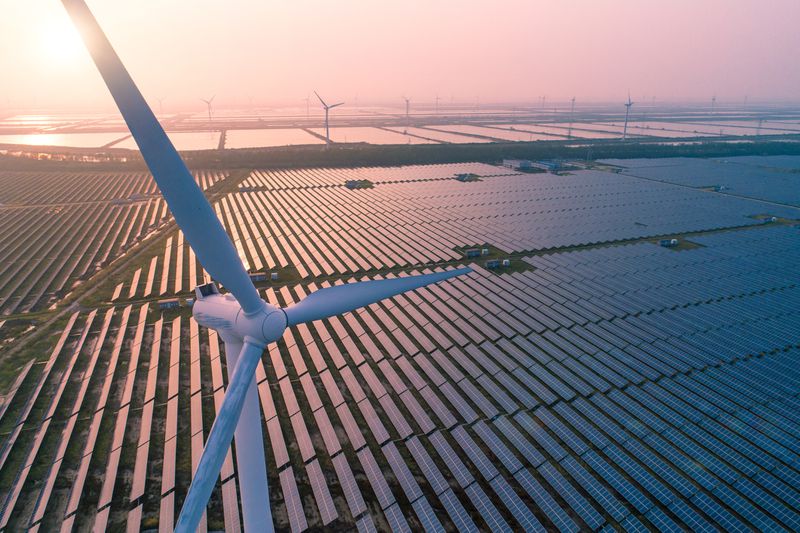 Wind turbine over a field of solar panels