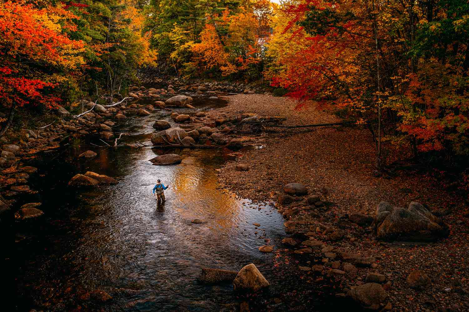 Fly fisherman in Conway, New Hampshire in autumn