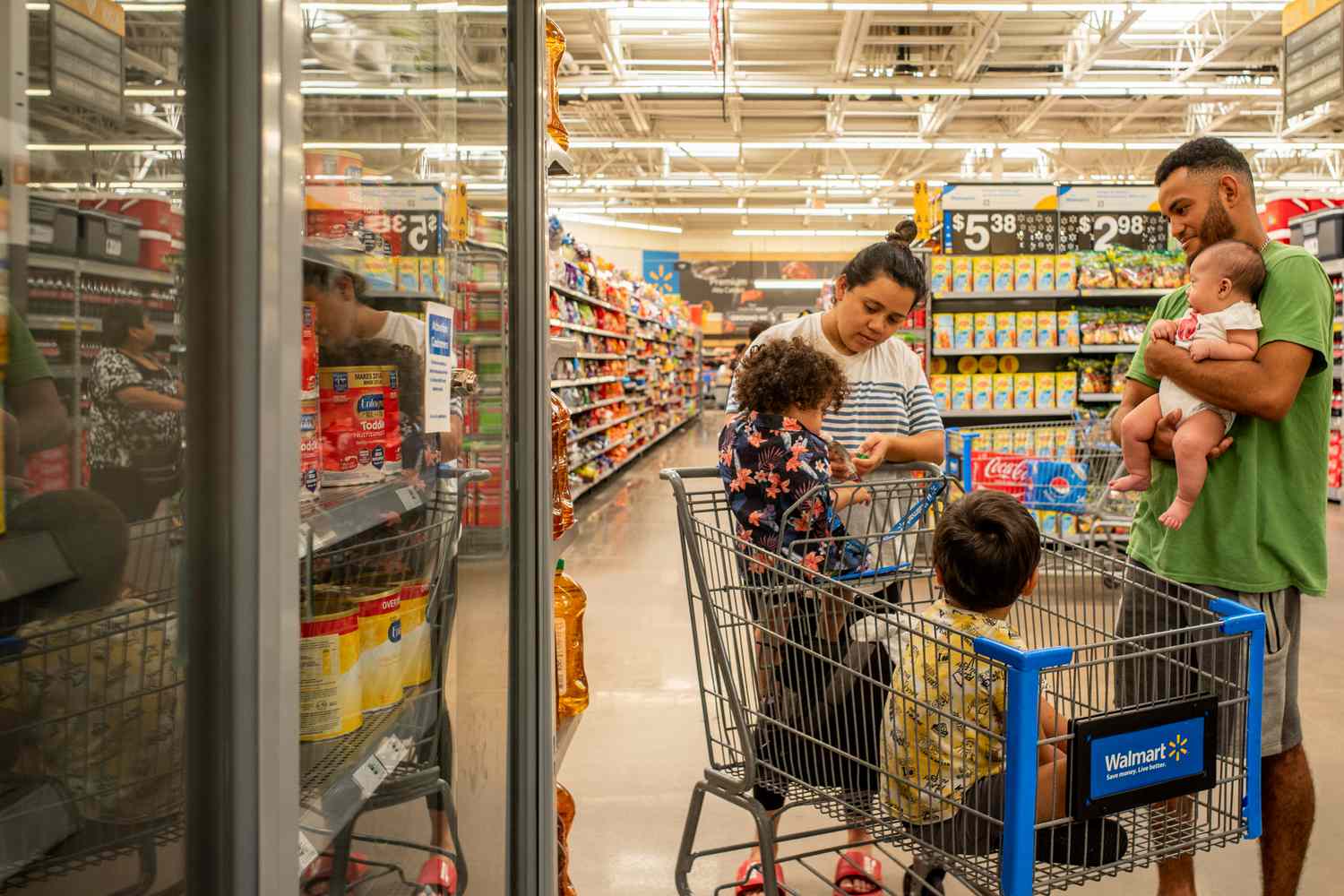 The Reyes family waits to receive baby formula in a Walmart Supercenter on July 08, 2022 in Houston, Texas. Consumer goods continue seeing shortages as the country grapples with ongoing supply chain issues stemming from the pandemic.