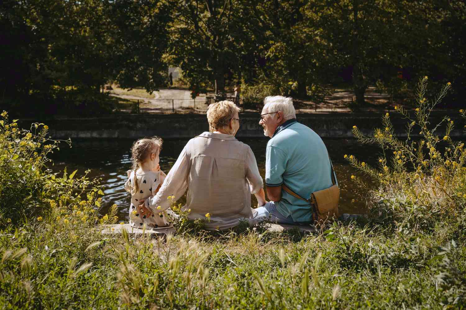 Older adults sitting with a child at a park