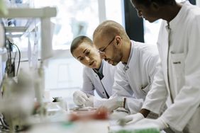 A group of scientists work together in a laboratory.