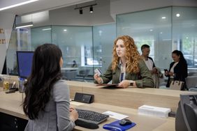 Young woman talks with bank teller