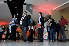 A group of people standing in line within an indoor public space