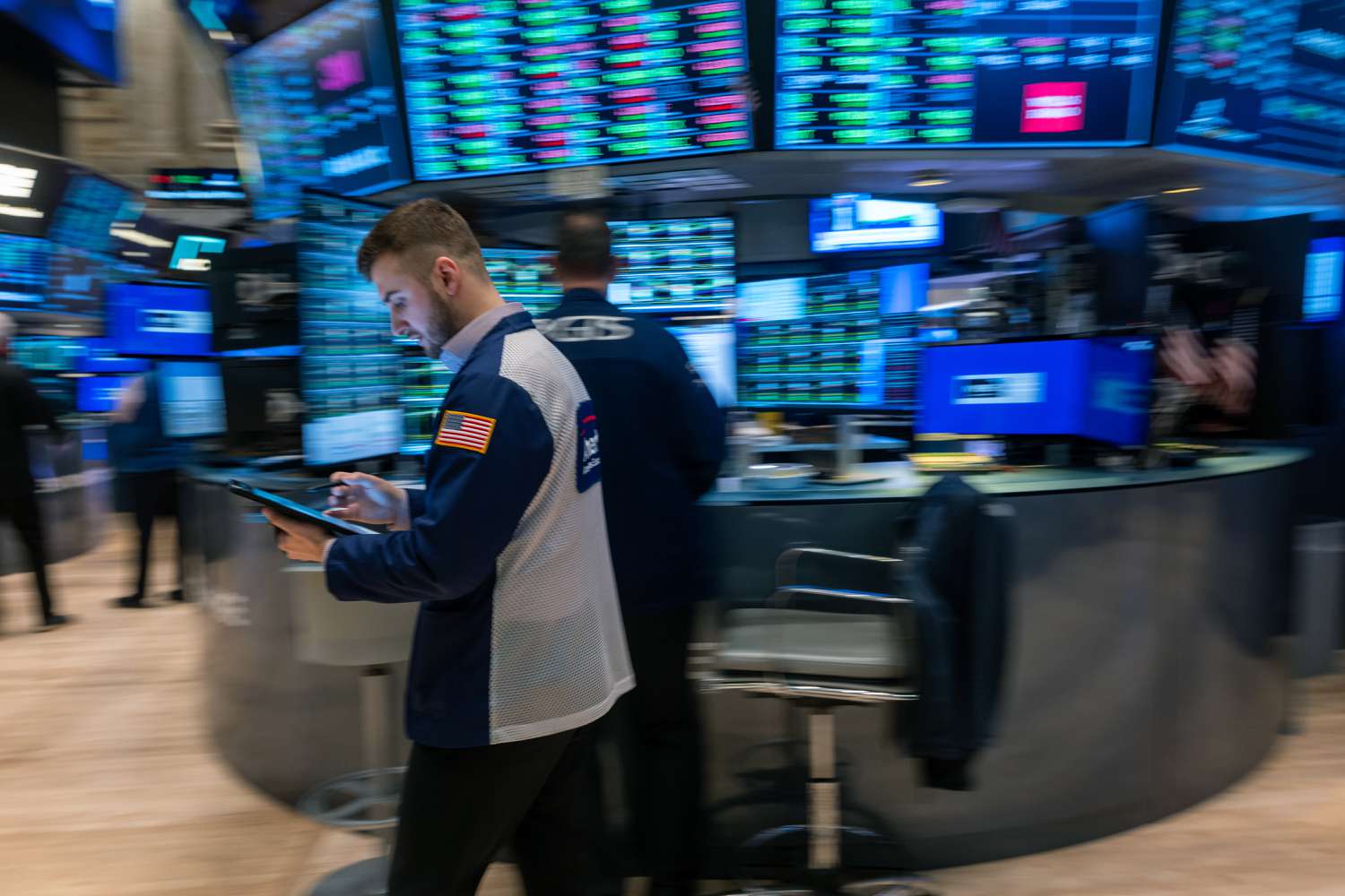 Traders work on the floor during morning trading at the New York Stock Exchange.