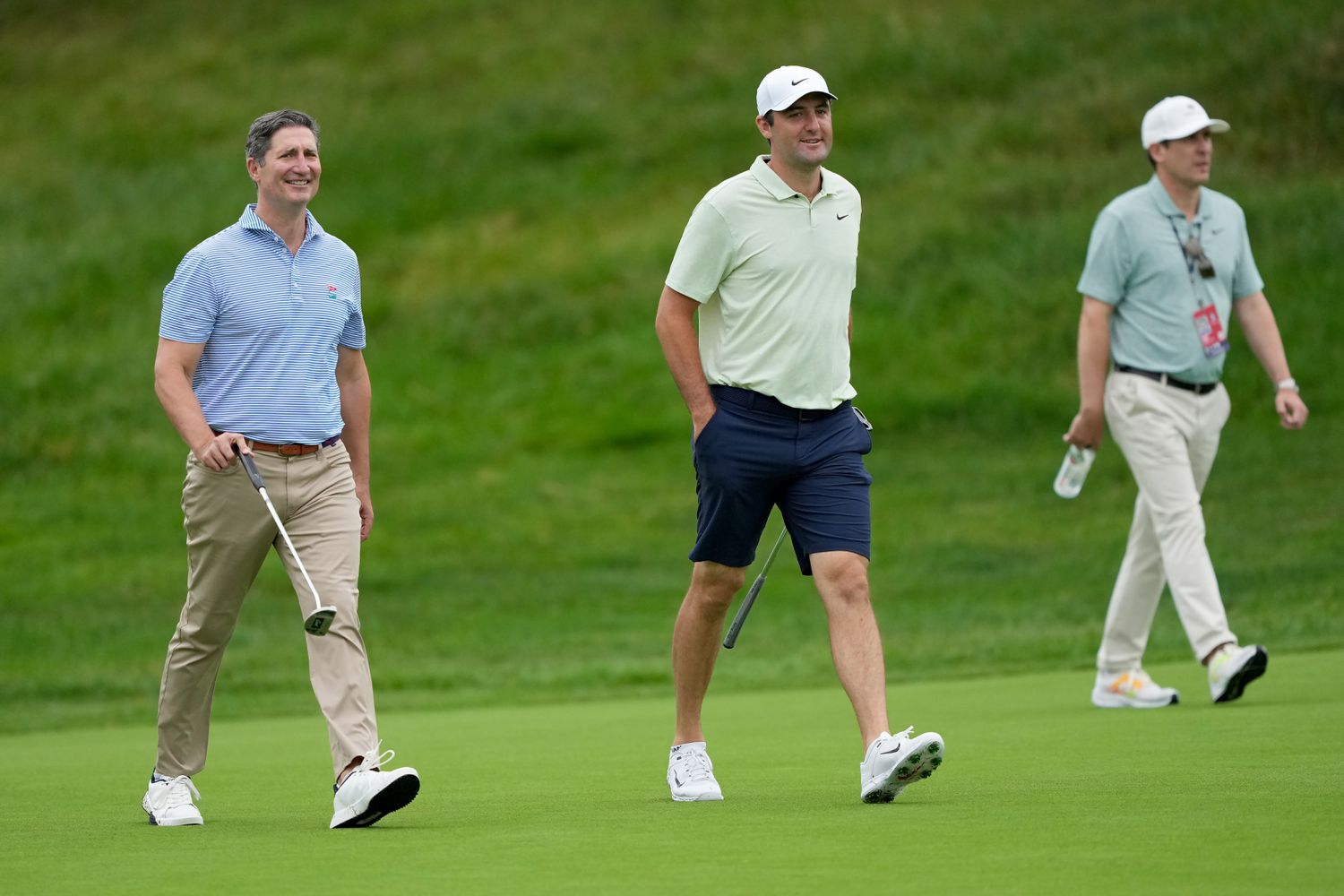 Chipotle CEO Brian Niccol (L) and Scottie Scheffler of the United States walk across the 14th hole during the Pro Am event prior to the Memorial Tournament presented by Workday at Muirfield Village Golf Club on June 05, 2024 in Dublin, Ohio. 