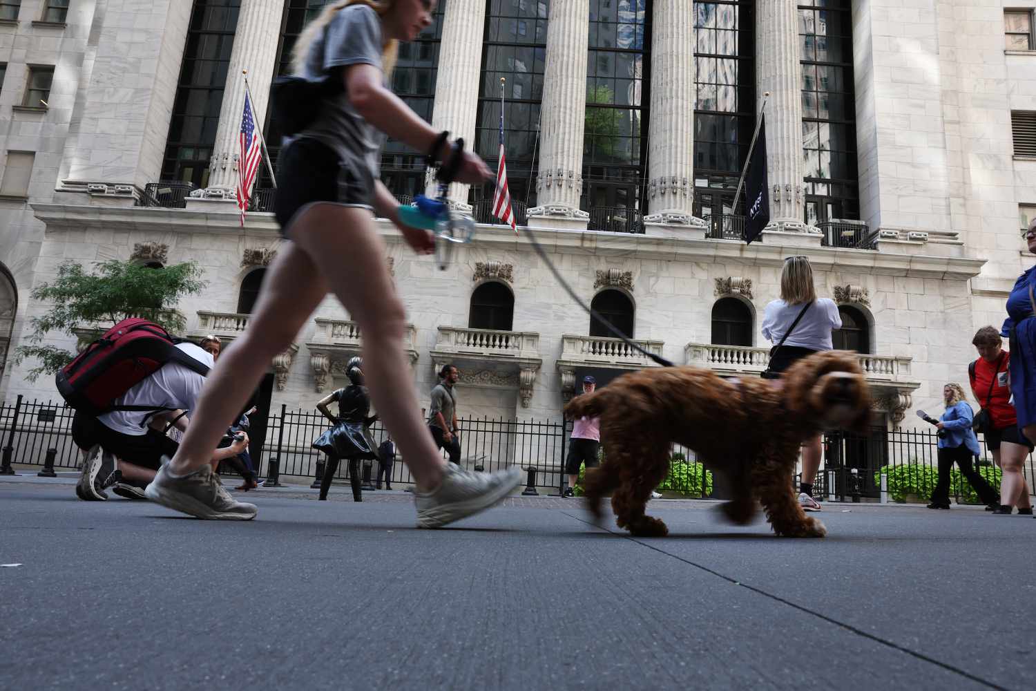 eople walk by the New York Stock Exchange (NYSE) on August 02, 2023 in New York City.