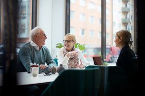 Older couple talking with a businesswoman