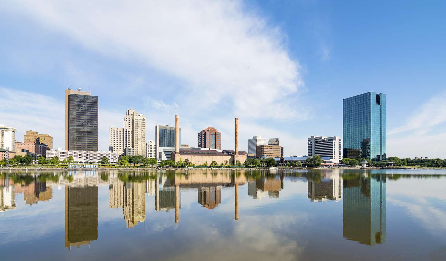 A panoramic view of downtown Toledo Ohio's skyline reflecting into the Maumee river. 