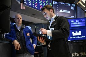 Traders work on the floor of the New York Stock Exchange