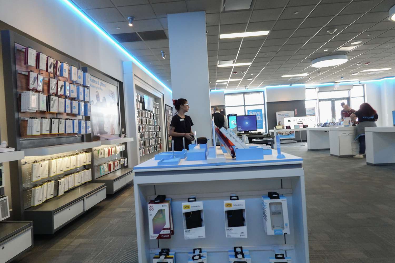 Workers and customers are seen on the sales floor of an AT&T store on April 01, 2024, in Miami