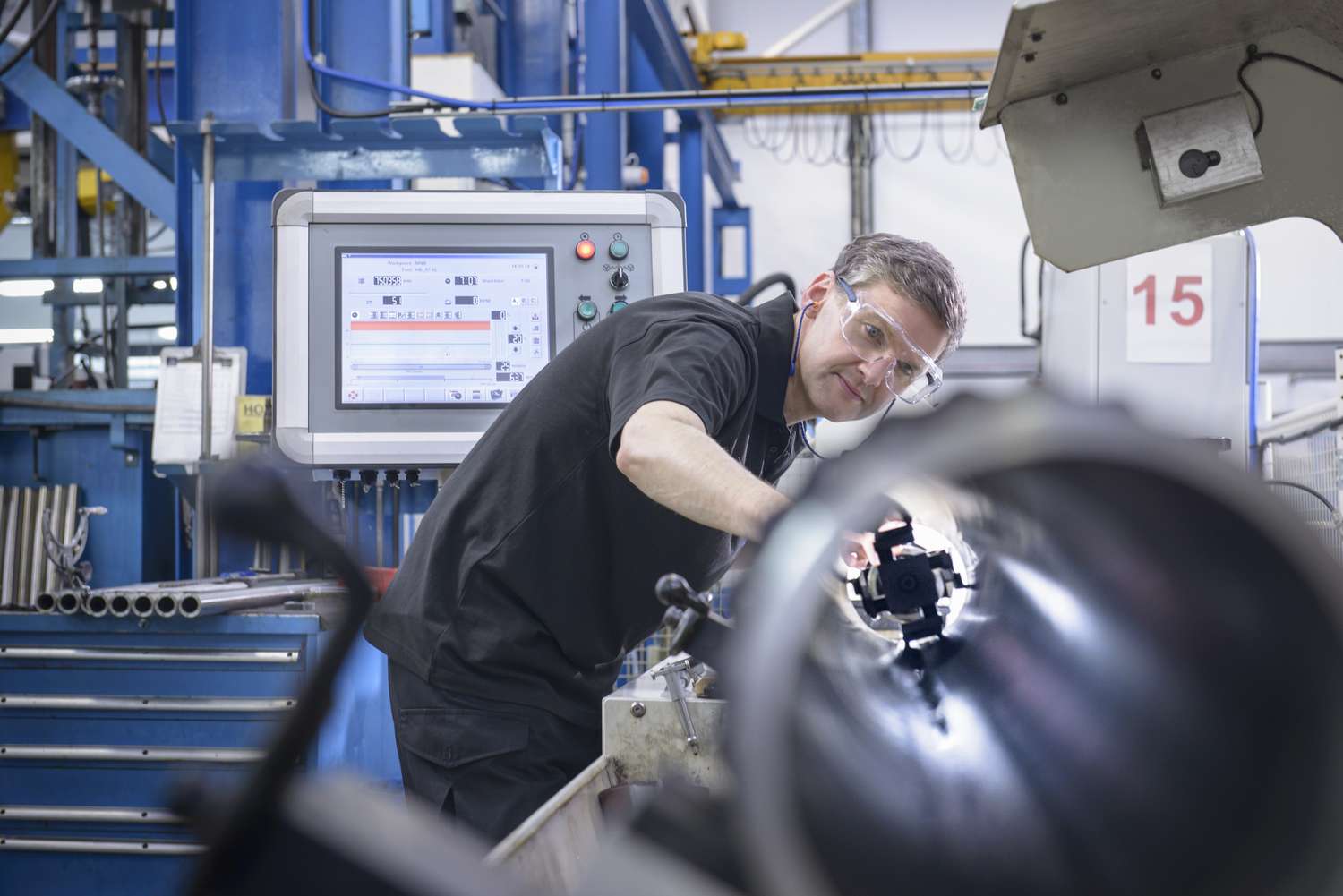 A man inspects machinery.
