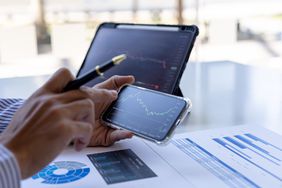 An investor looking at their investment portfolio holdings to see their current value