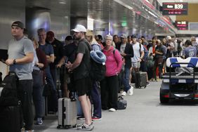 Passengers crowd in the departure lounge of Denver International Airport on July 20, 2024 in Denver, Colorado