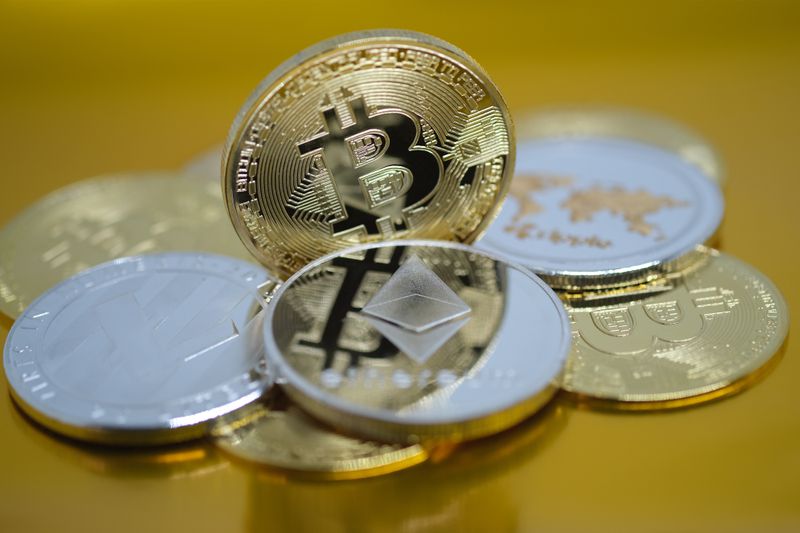 A photoillustration of physical representations of cryptocurrency. 