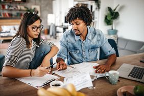Multi-ethnic couple planning their wedding budget