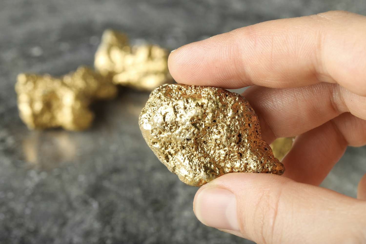 Person holding a gold nugget