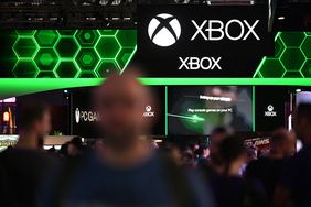 Visitors walk past the Xbox booth at the Gamescom video games trade fair in Cologne, western Germany on August 22, 2024