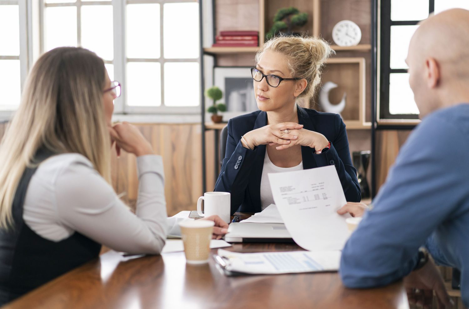 Couple talking with a lawyer in an office meeting