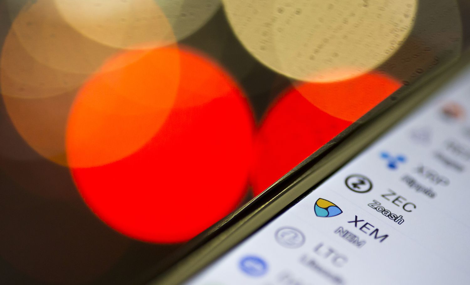 Logos of virtual currencies including the NEM coin against Japanese yen are seen on Coincheck's cryptocurrency wallet app in this arranged photograph on January 29, 2018 in Tokyo, Japan. 