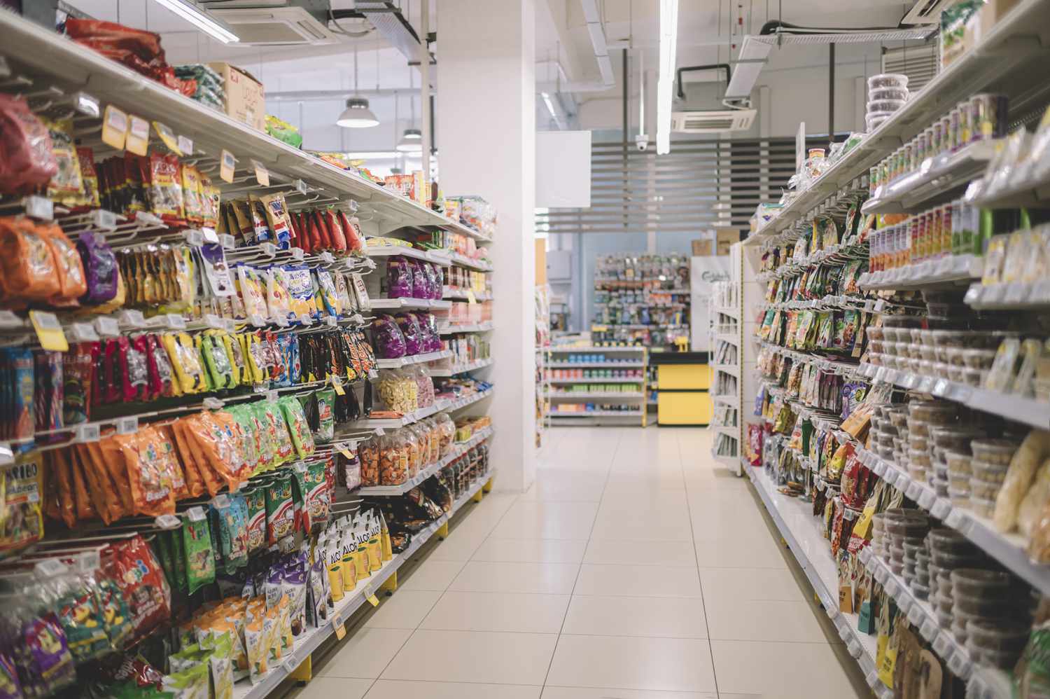 The snack aisle is shown in a supermarket. 