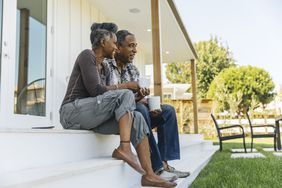 Elderly couple sitting outside on porch