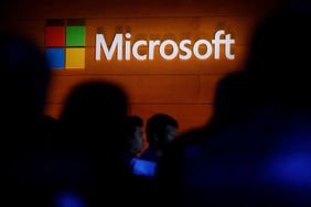 The Microsoft logo is illuminated on a wall during a Microsoft launch event to introduce the new Microsoft Surface laptop and Windows 10 S operating system, May 2, 2017 in New York City.